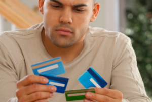man holding 4 credit cards